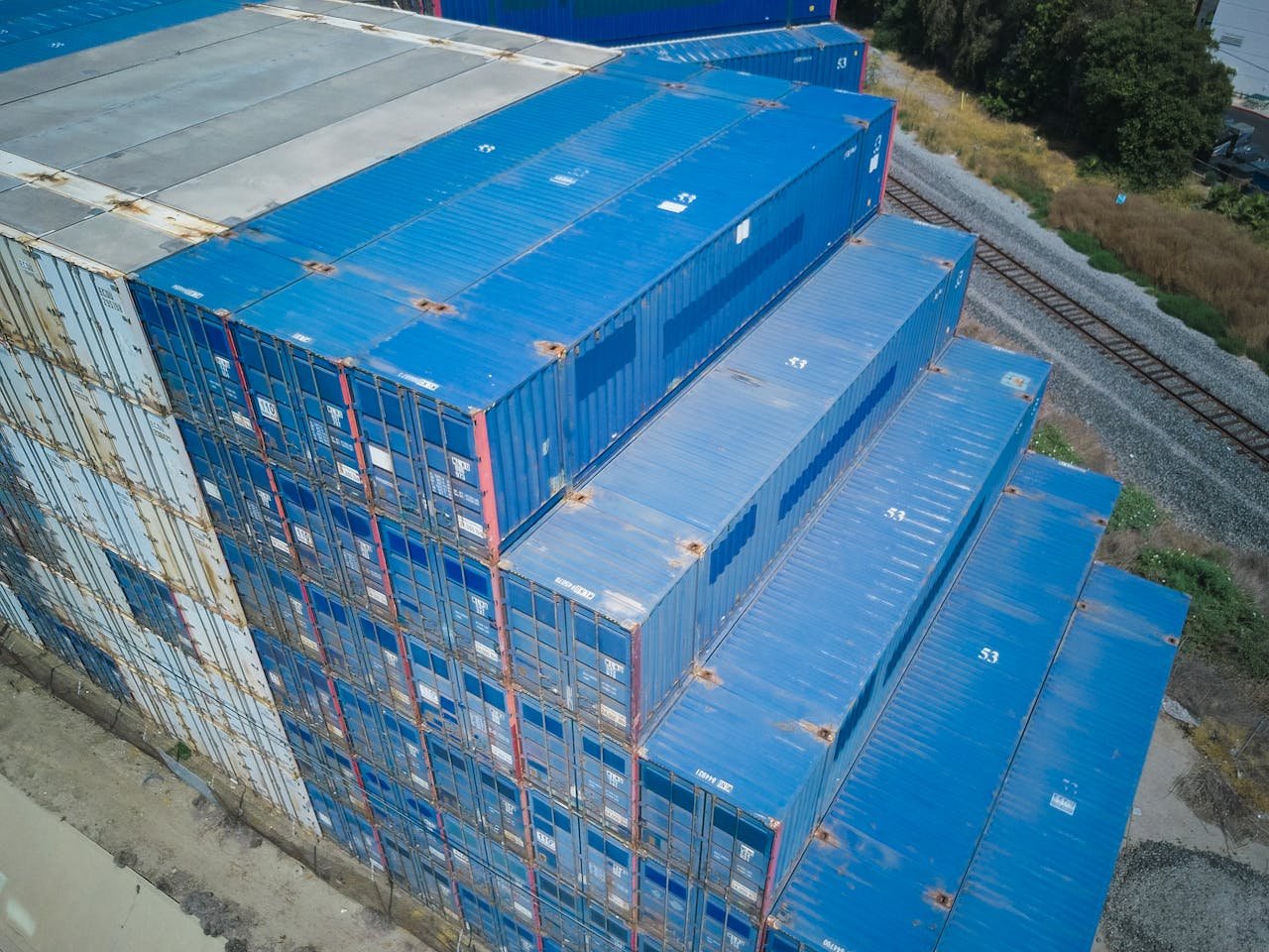 Overhead shot of blue cargo containers stacked for logistics and storage.